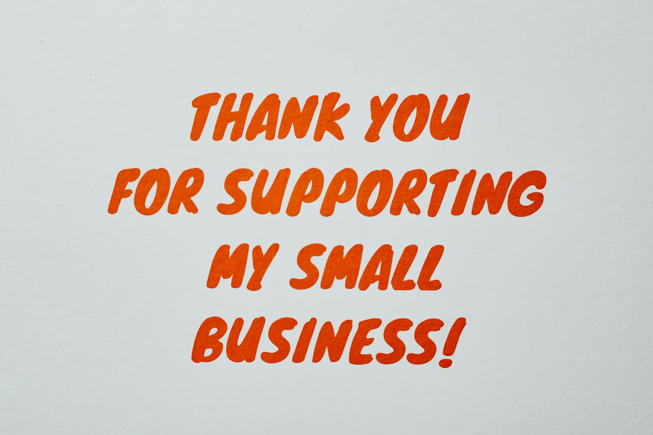 Simple 'Thank You' message in orange text on white background celebrating small business support.